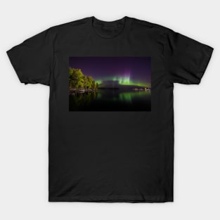 Northern lights glowing over lake in Finland T-Shirt